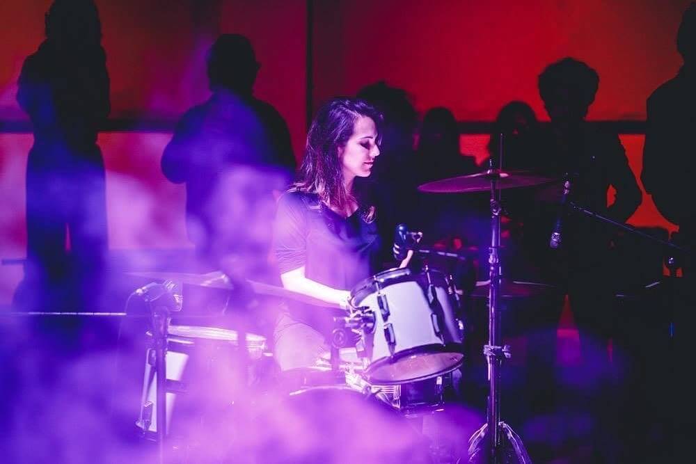 Carol Souza playing drums